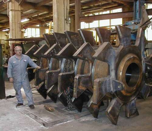 Large specialized weld fabrication of heavy plate and rolled cylinder to create hammer mill crusher rotor.