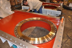 Large machined jet valve components being assembled.